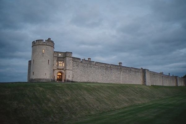 The stone walls and battlements of Windsor Castle seen from the town