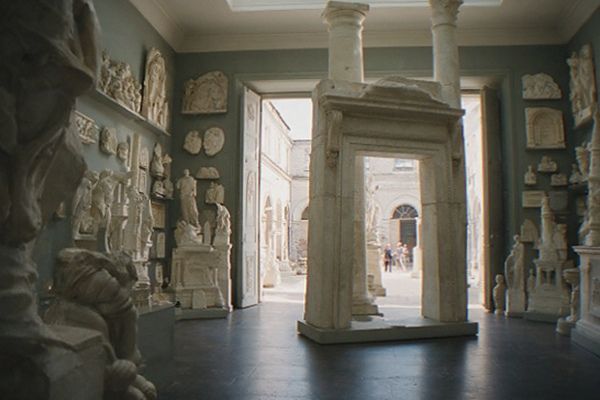 Sculpture gallery with tall stone columns and arched ceilings