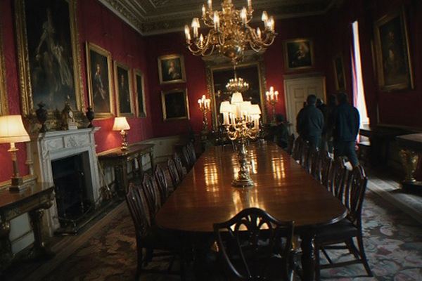 Display cases of historical garments lit against dark walls