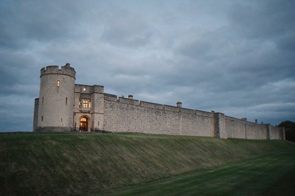 Windsor Castle round tower above the town rooftops seen from the long walk
